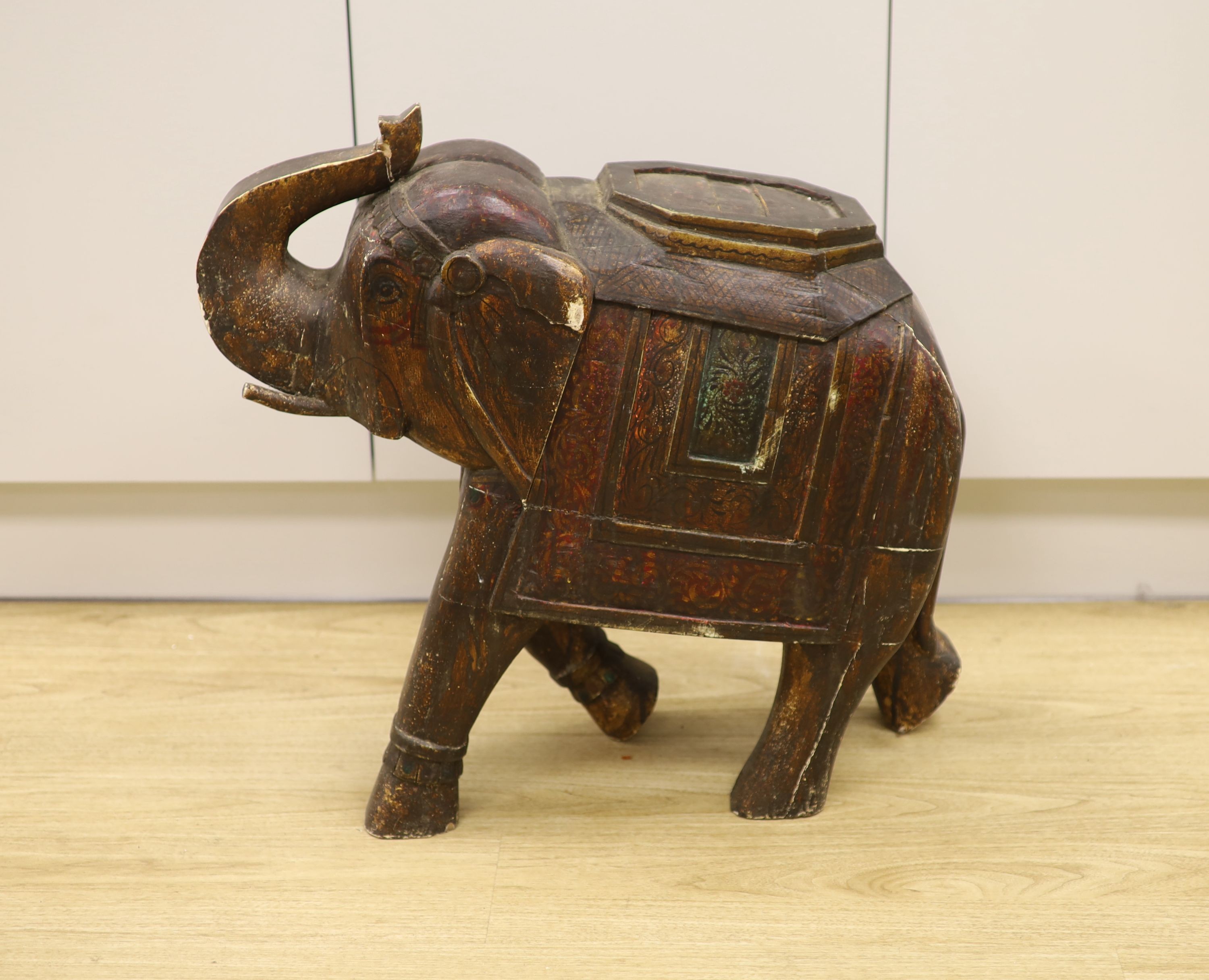 A large Indian painted and carved wood elephant figure, 59 cm high